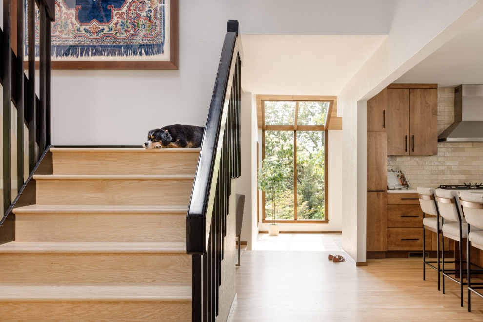 Mid-sized trendy wooden u-shaped metal railing staircase photo in Seattle with metal risers