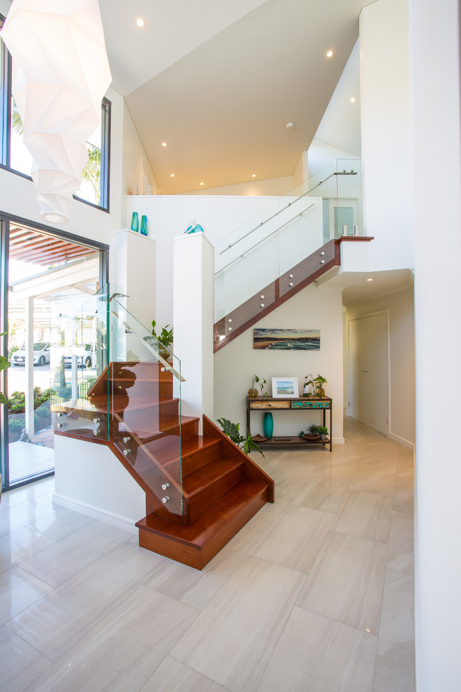 Contemporary wood u-shaped staircase in Brisbane with wood risers and glass railing.