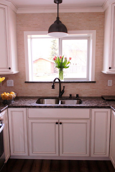 Enclosed kitchen - small transitional u-shaped dark wood floor enclosed kitchen idea with an undermount sink, beaded inset cabinets, white cabinets, quartzite countertops, beige backsplash and stainless steel appliances