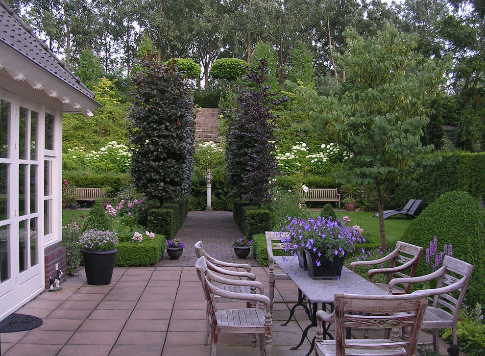 This is an example of a traditional garden in Other with with privacy feature.