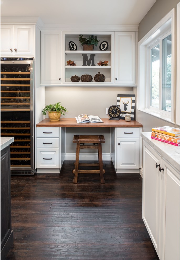 Inspiration for a traditional home office in Sacramento with dark hardwood floors, grey walls and a built-in desk.