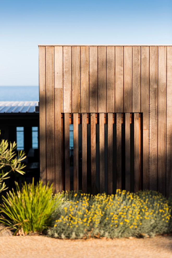 This is an example of a mid-sized beach style split-level exterior in Melbourne with wood siding.