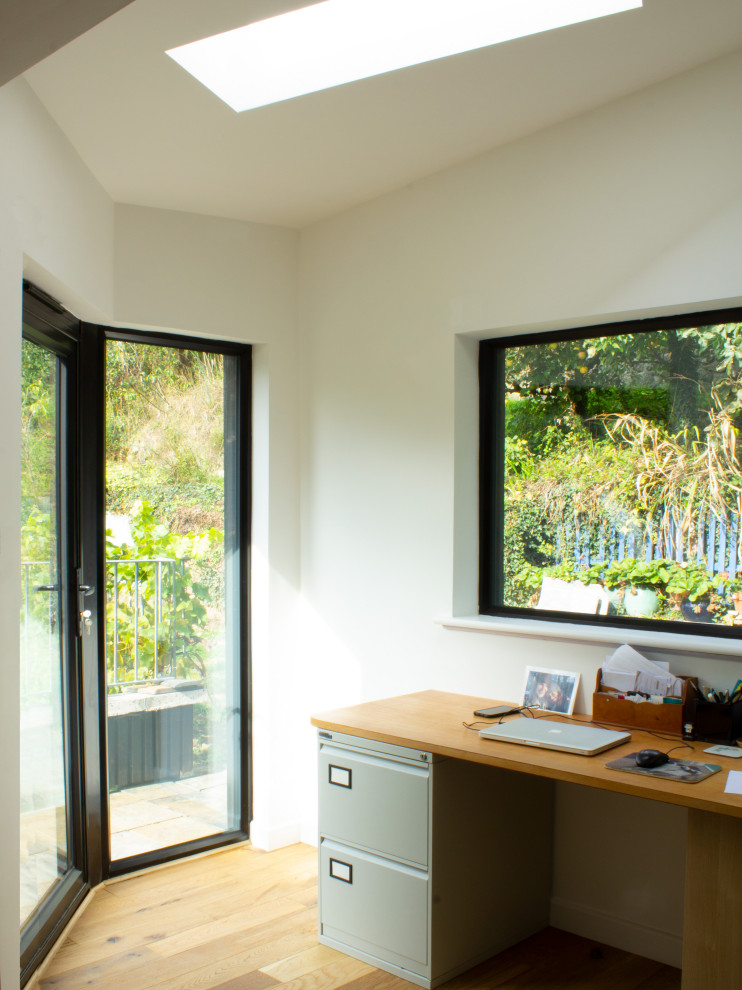 Photo of a small contemporary home studio in Devon with white walls, light hardwood flooring, a freestanding desk, beige floors, a coffered ceiling and feature lighting.