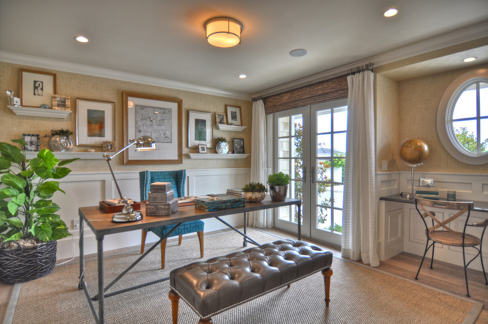 Photo of a beach style home office in Los Angeles with beige walls and medium hardwood floors.
