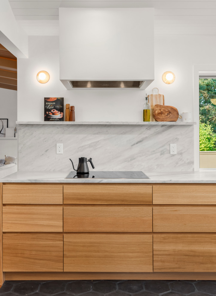 Design ideas for a midcentury kitchen in Portland with flat-panel cabinets, light wood cabinets, marble benchtops, marble splashback, terra-cotta floors, with island, black floor and vaulted.