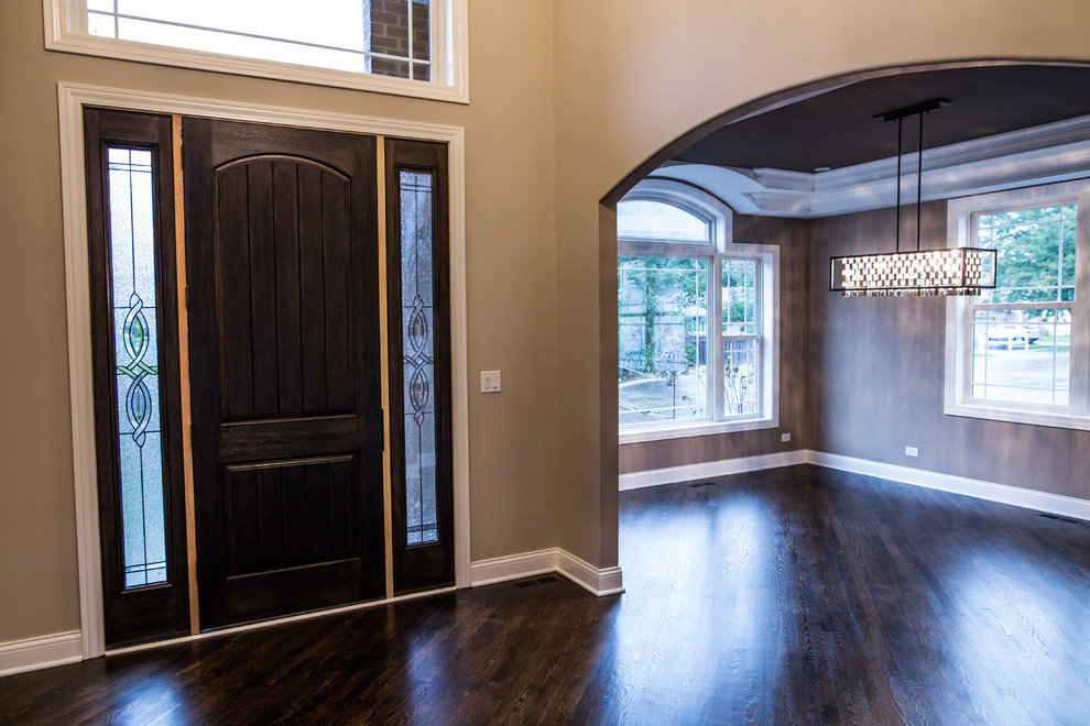 Inspiration for a mid-sized transitional dark wood floor home design remodel in Chicago with brown walls and a black front door