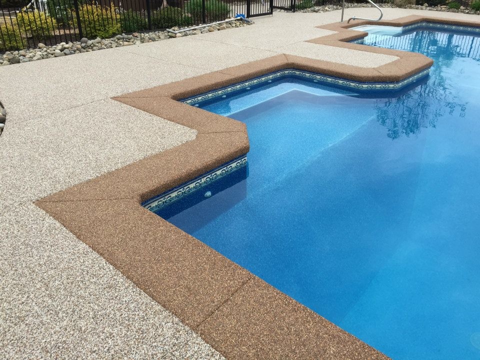 Example of a mid-sized transitional backyard concrete and custom-shaped pool design