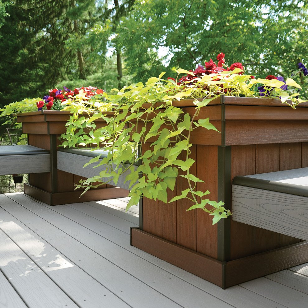 Example of a large transitional backyard deck design in New York with a pergola
