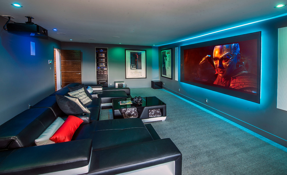 Photo of a large contemporary enclosed home theatre in San Francisco with carpet, grey walls, a projector screen and grey floor.