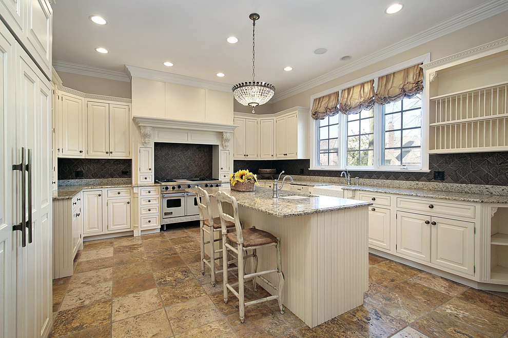 Example of a large tuscan u-shaped marble floor enclosed kitchen design in Los Angeles with an undermount sink, recessed-panel cabinets, white cabinets, granite countertops, black backsplash, an island, mosaic tile backsplash and white appliances