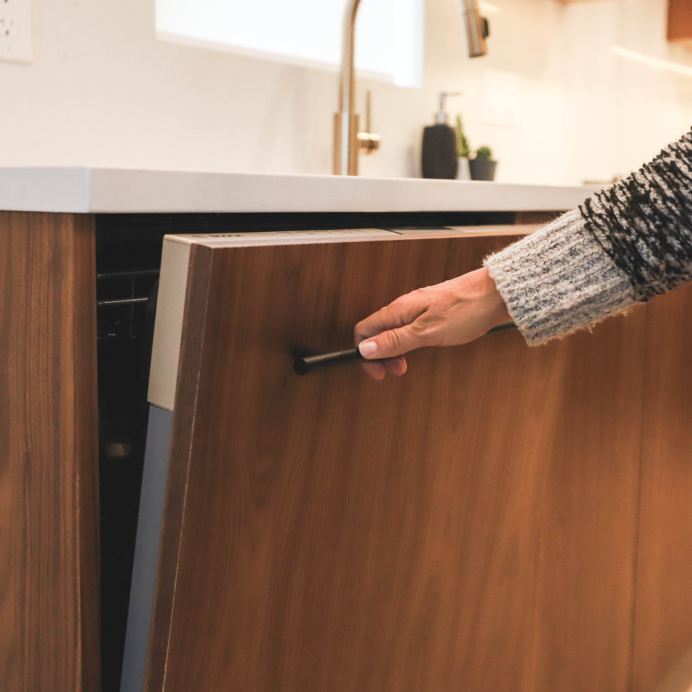 Inspiration for a l-shaped light wood floor open concept kitchen remodel with flat-panel cabinets, medium tone wood cabinets, quartzite countertops, stainless steel appliances and an island