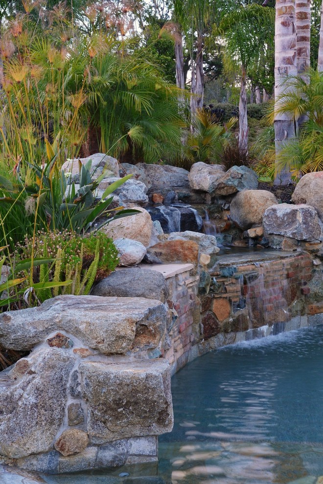 Photo of a large mediterranean backyard garden in San Diego with a water feature.