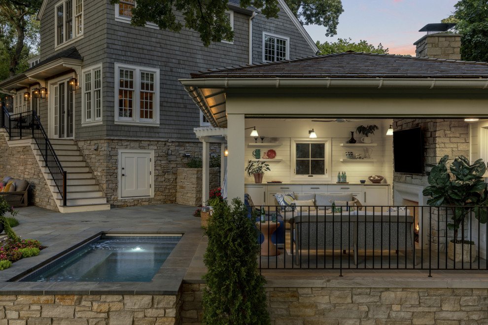 Photo of a traditional backyard rectangular pool in Minneapolis with a pool house.
