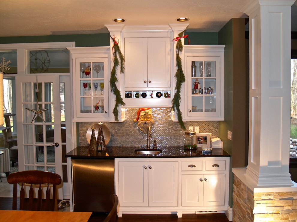 Example of a transitional kitchen design in Milwaukee with multicolored backsplash, mosaic tile backsplash, stainless steel appliances and two islands