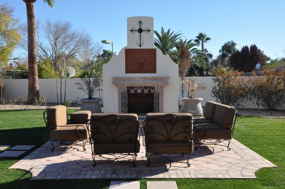 Design ideas for a mediterranean patio in Phoenix with with fireplace.