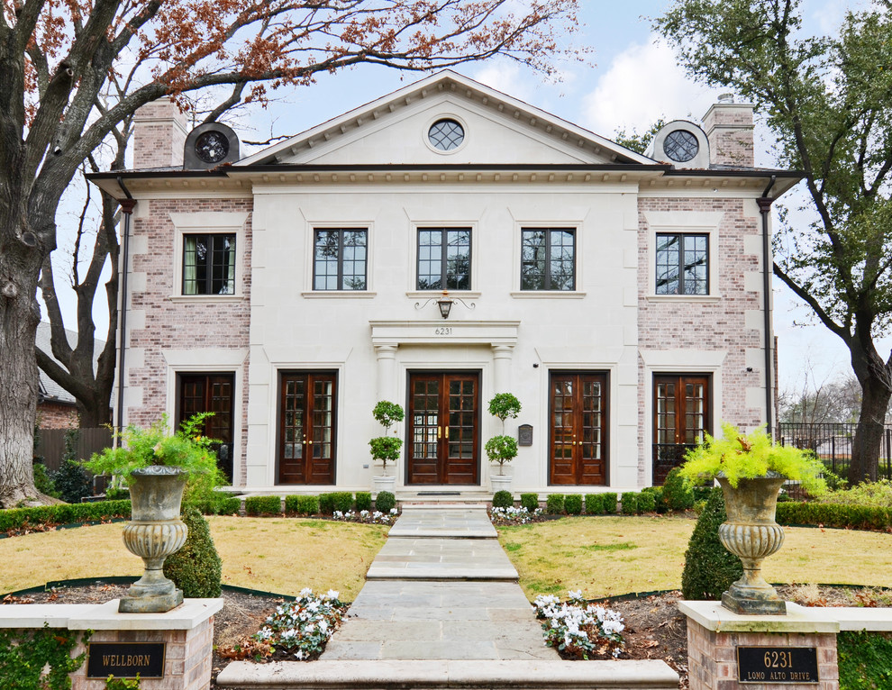 Inspiration for a large traditional two-storey brick exterior in Dallas with a gable roof.