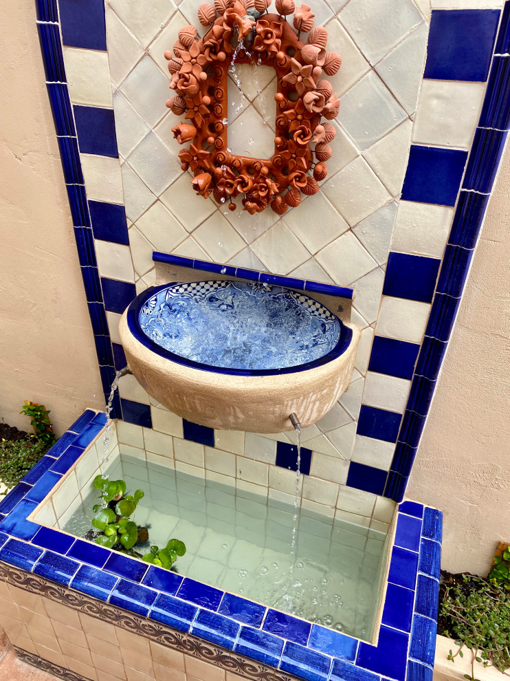 Design ideas for a small mediterranean back patio in San Diego with a water feature, tiled flooring and no cover.