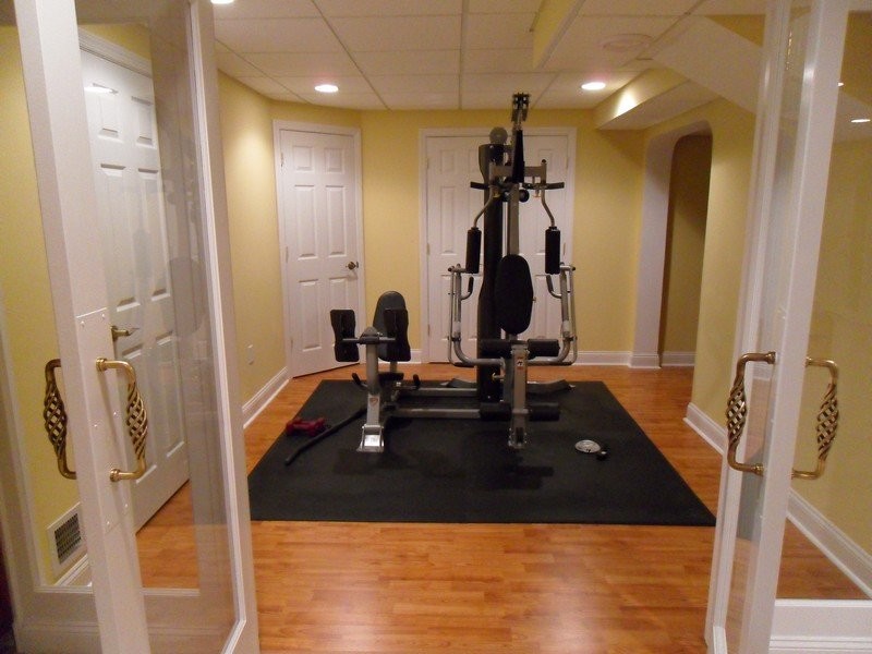 This is an example of a mid-sized traditional home weight room in New York with yellow walls and medium hardwood floors.