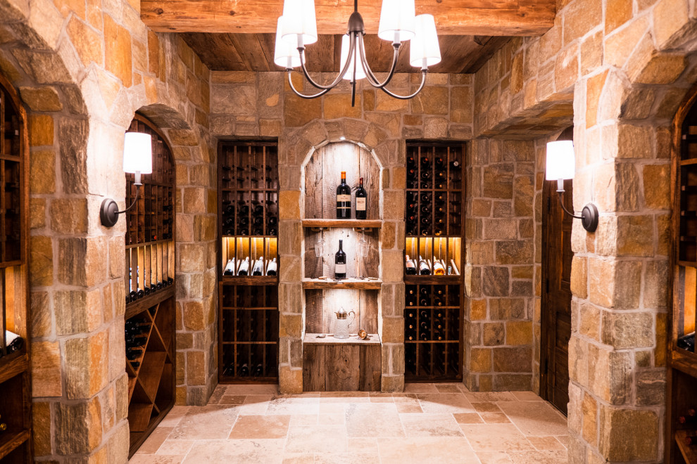 Inspiration for a mid-sized traditional wine cellar in New York with travertine floors, storage racks and beige floor.