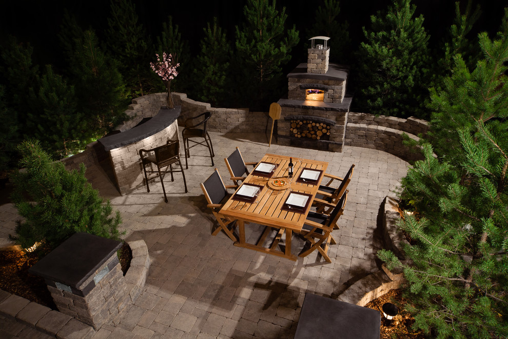 Large traditional backyard patio in Other with an outdoor kitchen, concrete pavers and no cover.