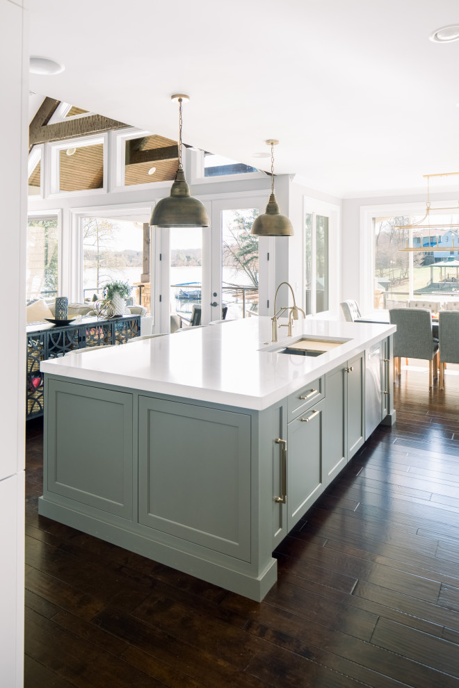 Eat-in kitchen - mid-sized transitional single-wall dark wood floor, brown floor and exposed beam eat-in kitchen idea with an undermount sink, shaker cabinets, white cabinets, quartz countertops, white backsplash, subway tile backsplash, stainless steel appliances, an island and white countertops