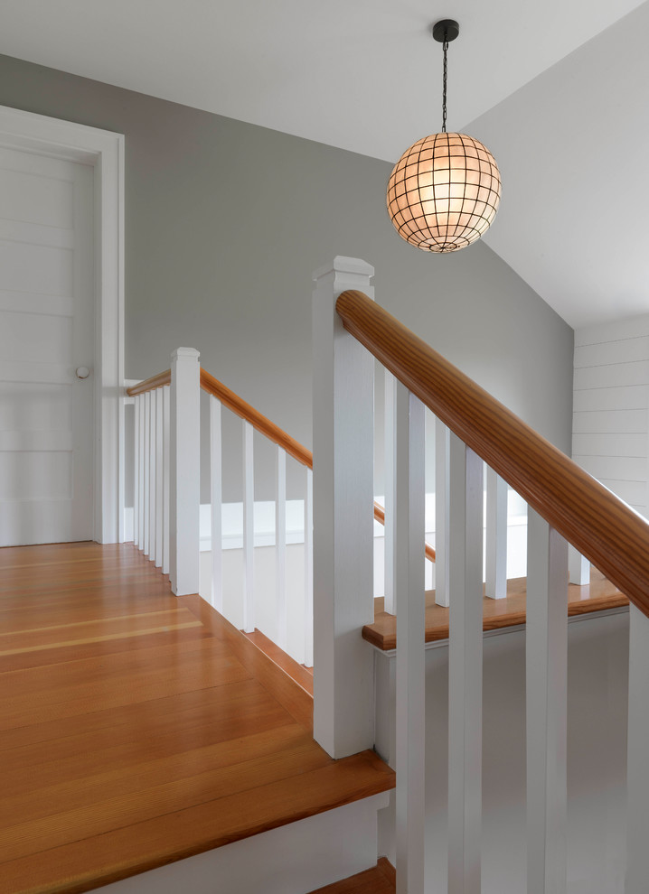 Wooden u-shaped wood railing staircase photo in Burlington with painted risers