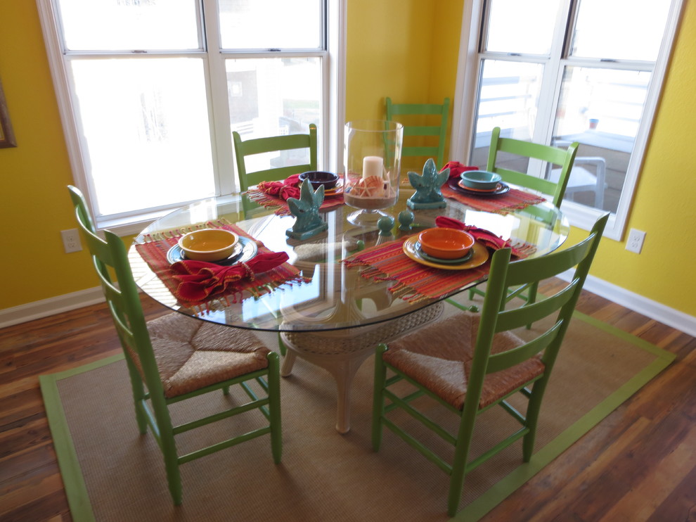 Photo of a beach style dining room in Other with yellow walls.