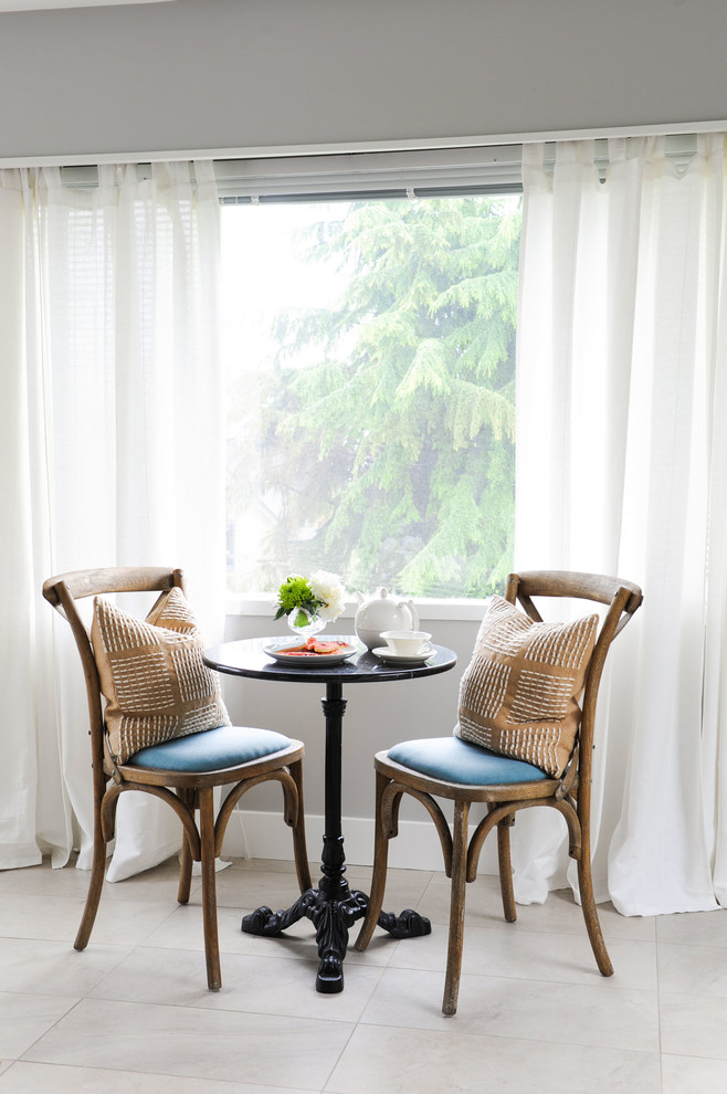 Example of a transitional ceramic tile and gray floor dining room design with gray walls
