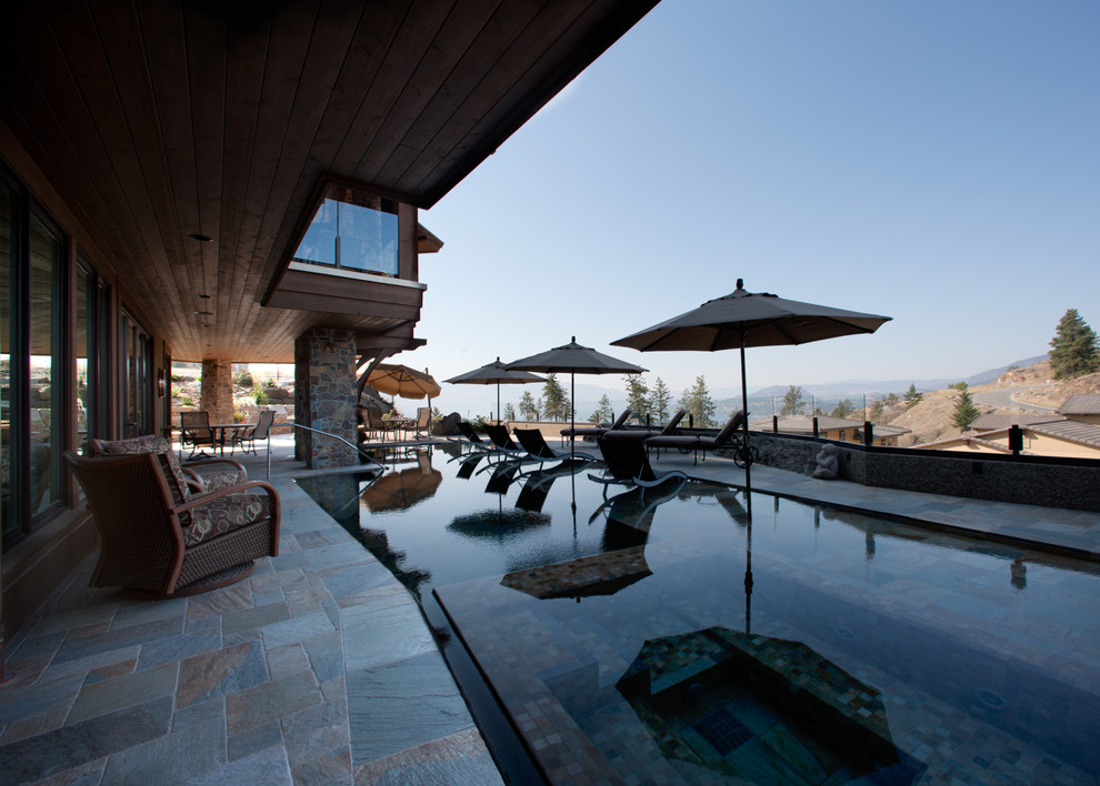 Mid-sized backyard stone and rectangular pool house photo