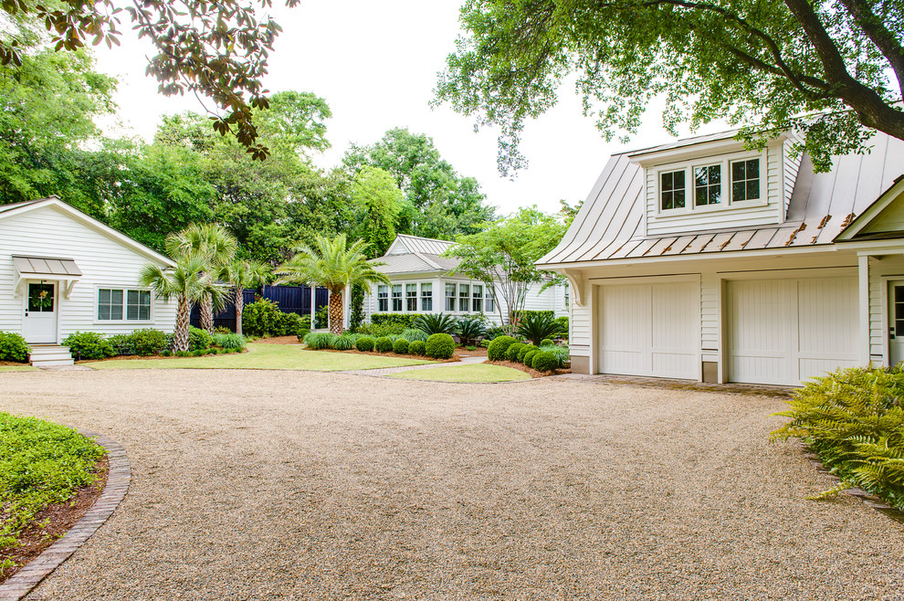Expansive country front yard partial sun driveway in Charleston with gravel.