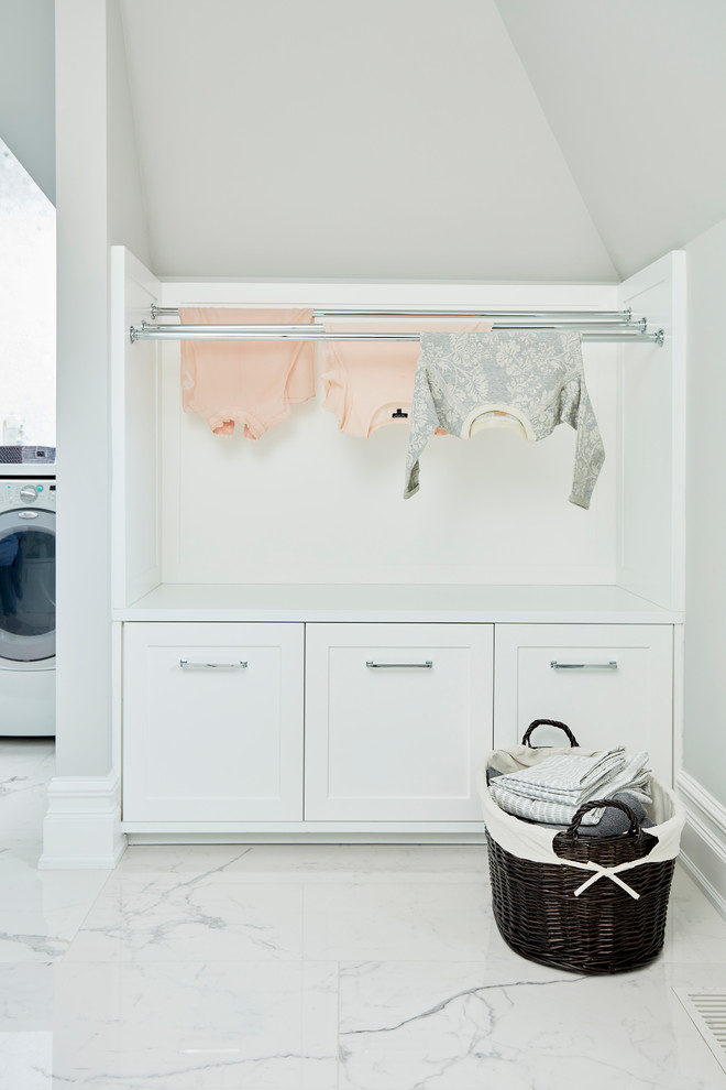 Large transitional u-shaped dedicated laundry room in Toronto with an undermount sink, recessed-panel cabinets, white cabinets, quartz benchtops, grey walls, porcelain floors, a side-by-side washer and dryer, multi-coloured floor and white benchtop.