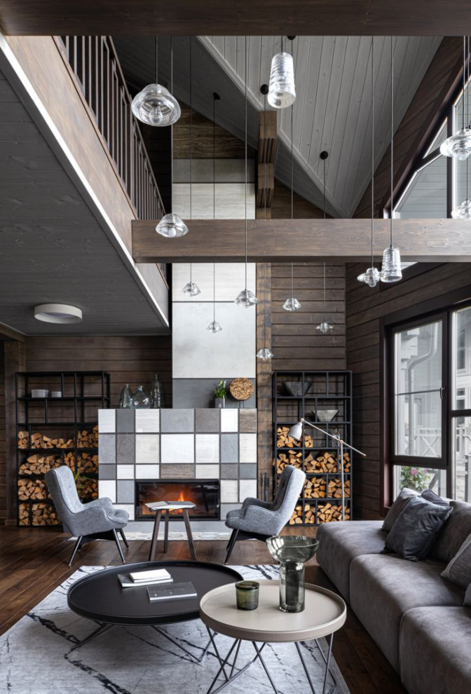 This is an example of a large contemporary formal loft-style living room in Moscow with brown walls, medium hardwood floors, a standard fireplace, a tile fireplace surround and brown floor.