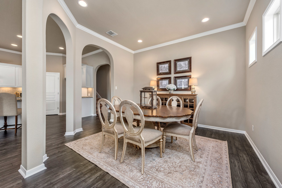 This is an example of a mid-sized arts and crafts open plan dining in Austin with beige walls, laminate floors, a corner fireplace, a stone fireplace surround and multi-coloured floor.