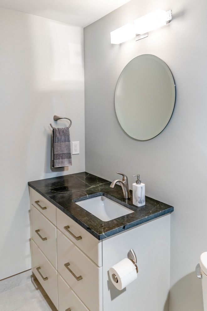 Design ideas for a small transitional bathroom in Seattle with flat-panel cabinets, white cabinets, an alcove tub, a shower/bathtub combo, a one-piece toilet, blue tile, white walls, ceramic floors, an undermount sink, quartzite benchtops, grey floor, an open shower, grey benchtops, a single vanity, a freestanding vanity and porcelain tile.