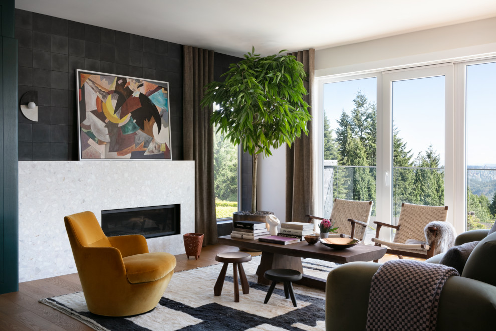 Photo of a midcentury living room in Vancouver with black walls, medium hardwood floors, a stone fireplace surround, a ribbon fireplace and brown floor.