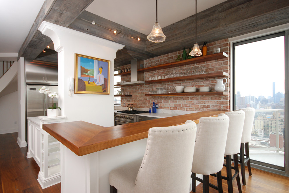 This is an example of an eclectic kitchen in New York with wood benchtops.