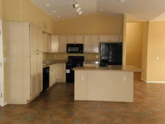 Kitchen - kitchen idea in Phoenix with light wood cabinets and black appliances