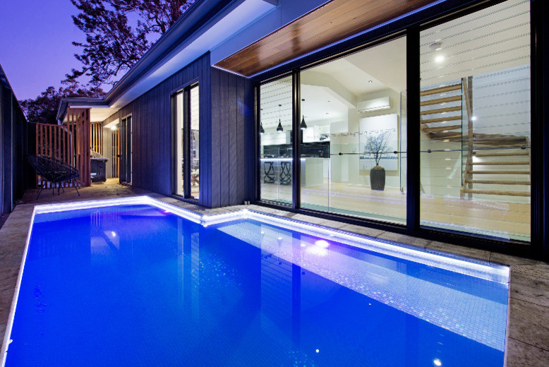 Inspiration for a contemporary side yard rectangular lap pool in Brisbane.
