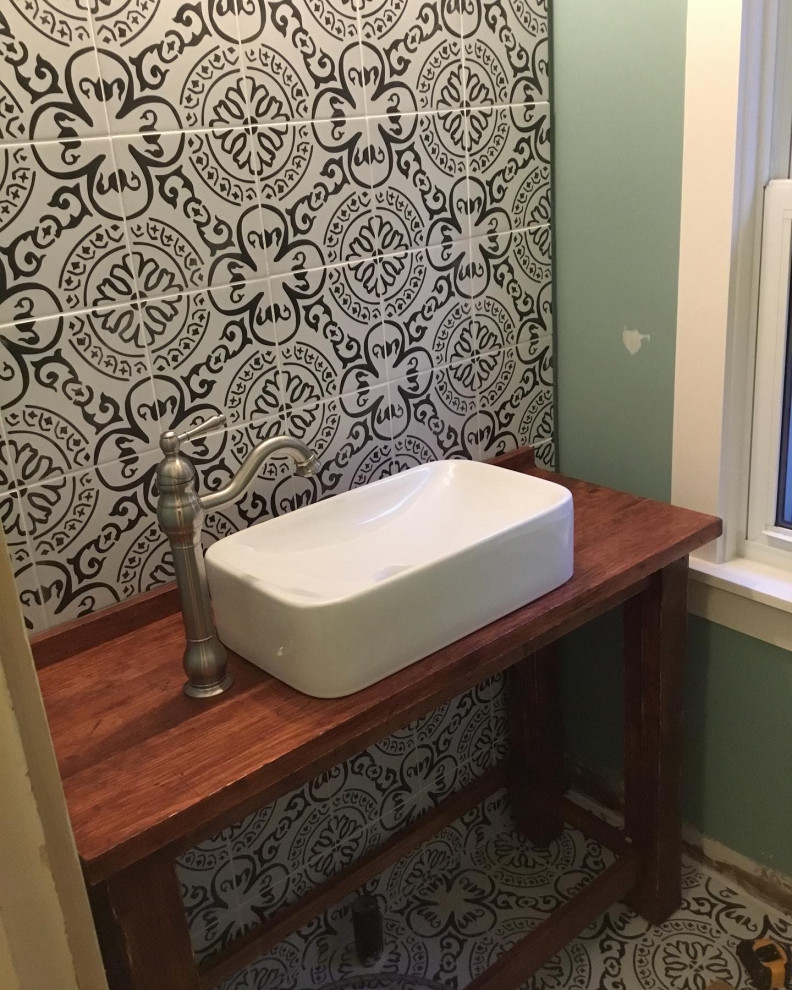 Small country bathroom in Bridgeport with open cabinets, brown cabinets, a two-piece toilet, black and white tile, porcelain tile, green walls, porcelain floors, a vessel sink, wood benchtops and brown benchtops.
