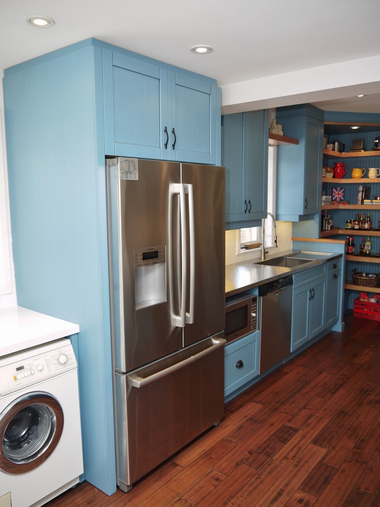 Country separate kitchen in Toronto with an undermount sink, shaker cabinets, blue cabinets, solid surface benchtops, white splashback, porcelain splashback and stainless steel appliances.