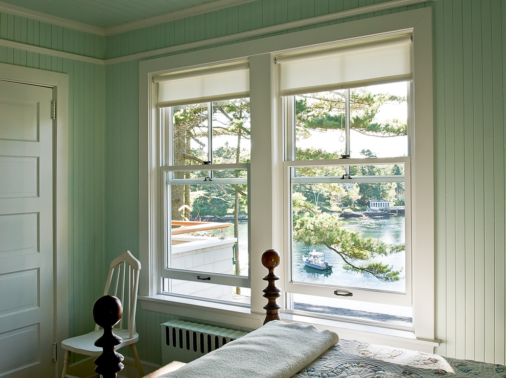Design ideas for a beach style bedroom in Portland Maine with green walls.