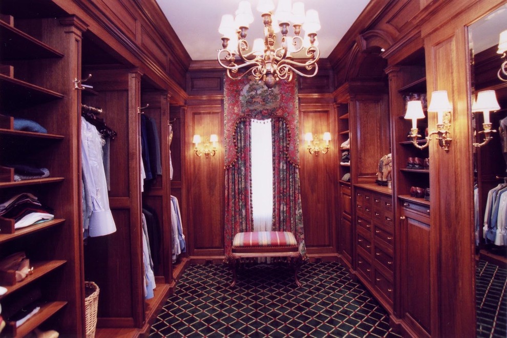 Mid-sized traditional men's dressing room in Philadelphia with raised-panel cabinets, medium wood cabinets, carpet and blue floor.