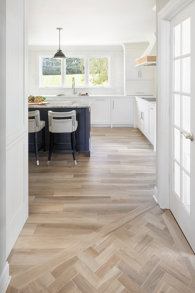 Mid-sized transitional u-shaped porcelain tile and beige floor eat-in kitchen photo in Bridgeport with an undermount sink, shaker cabinets, white cabinets, quartzite countertops, white backsplash, mosaic tile backsplash, stainless steel appliances, an island and multicolored countertops