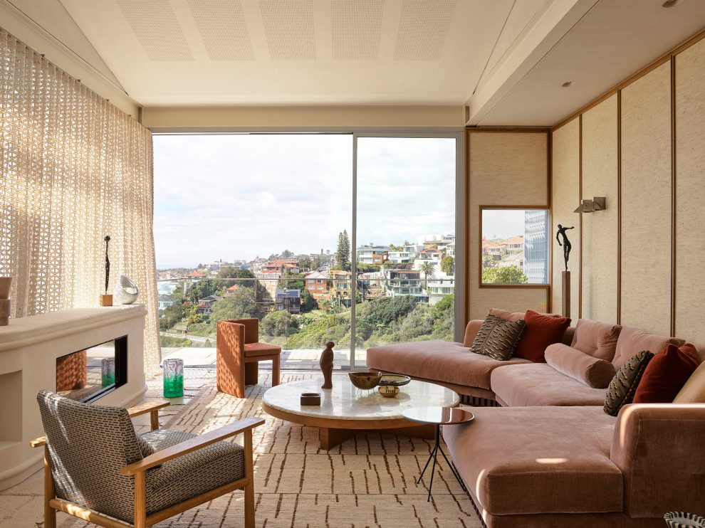 This is an example of a contemporary open concept living room in Sydney with beige walls, a ribbon fireplace, beige floor, panelled walls and a plaster fireplace surround.