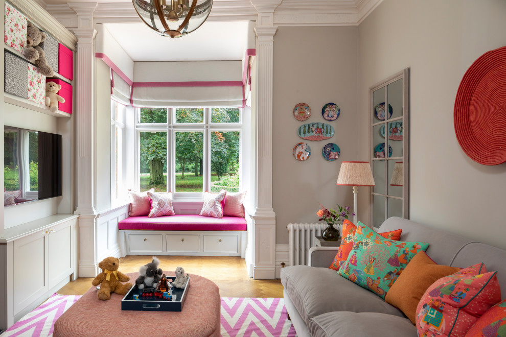 Design ideas for a classic kids' bedroom for girls in London with beige walls, medium hardwood flooring and brown floors.