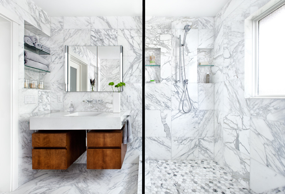 This is an example of a contemporary bathroom in Austin with flat-panel cabinets, medium wood cabinets, an alcove shower, white tile and marble.