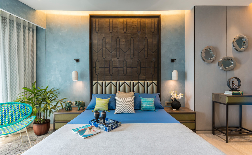 This is an example of a contemporary bedroom in Mumbai with blue walls.