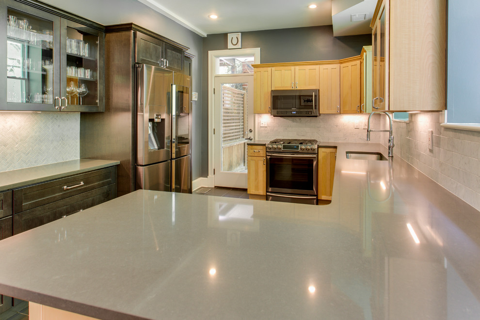 Example of a mid-sized transitional kitchen design in DC Metro with recessed-panel cabinets, quartz countertops, stainless steel appliances and a peninsula