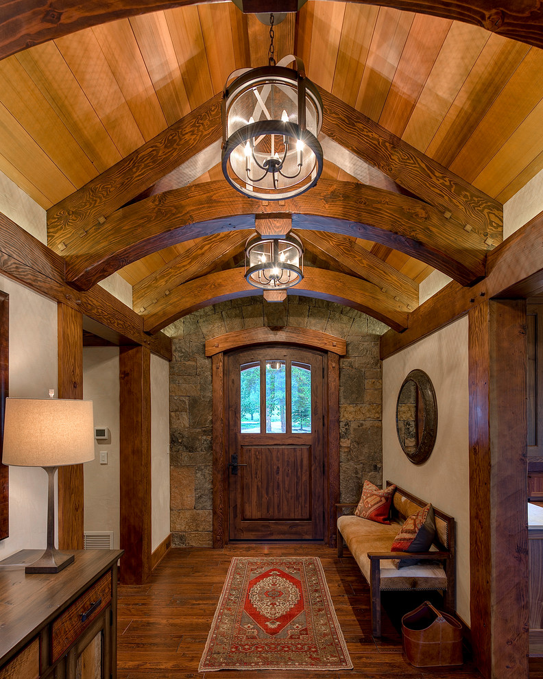 Design ideas for a country foyer in Denver with beige walls, dark hardwood floors, a single front door, a dark wood front door and brown floor.