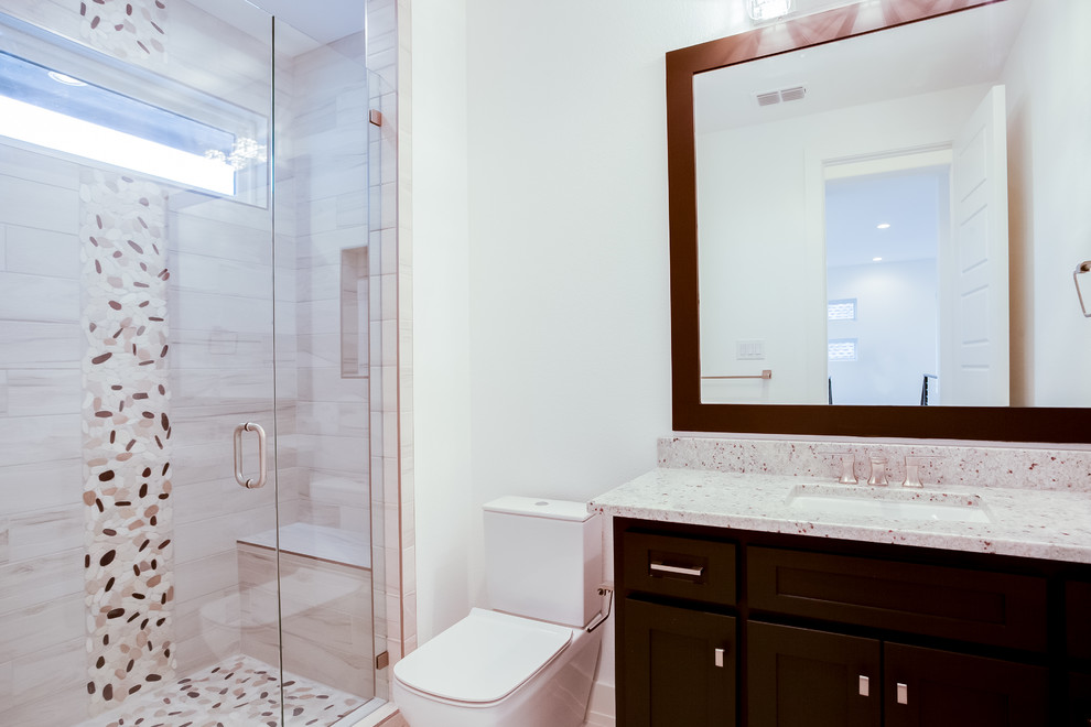 Inspiration for a mid-sized modern kids bathroom in Dallas with recessed-panel cabinets, brown cabinets, a curbless shower, white tile, ceramic tile, white walls, medium hardwood floors, an undermount sink, granite benchtops, brown floor, a hinged shower door and white benchtops.
